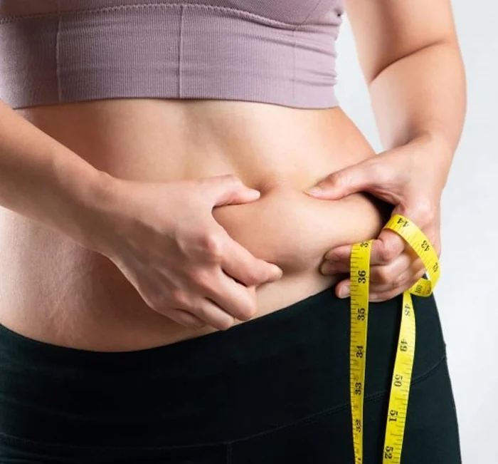 A woman measuring her waist with a tape measure, the weight management goal Gelataro is marketed for